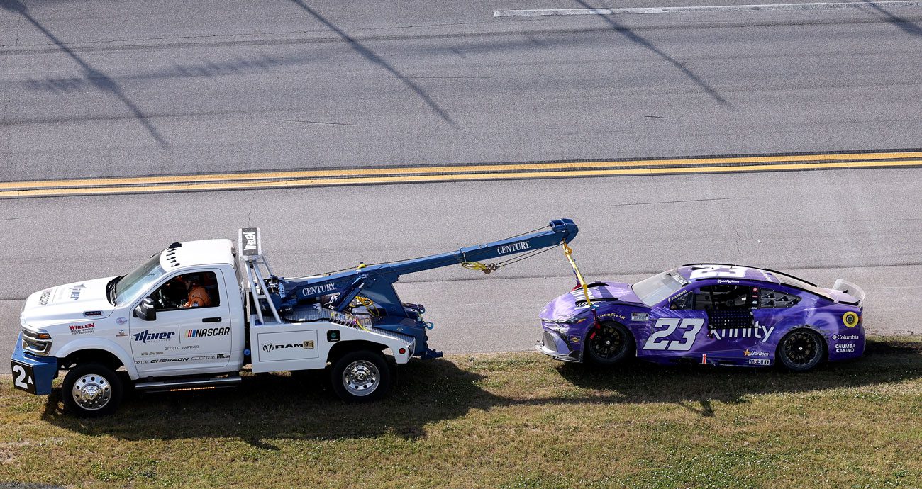 Bubba Wallace's No. 23 car is towed to the Talladega garage.