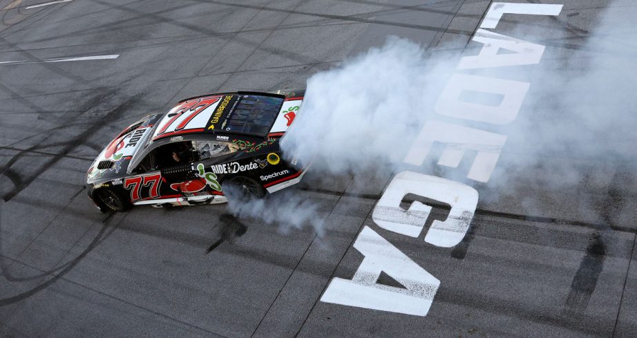 Carson Hocevar does a victory burnout in the No. 77 Spire Motorsports Chevrolet at Talladega Superspeedway.