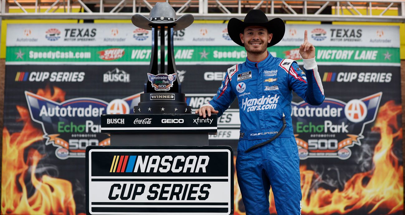 Kyle Larson poses for a photo in Victory Lane at Texas Motor Speedway.
