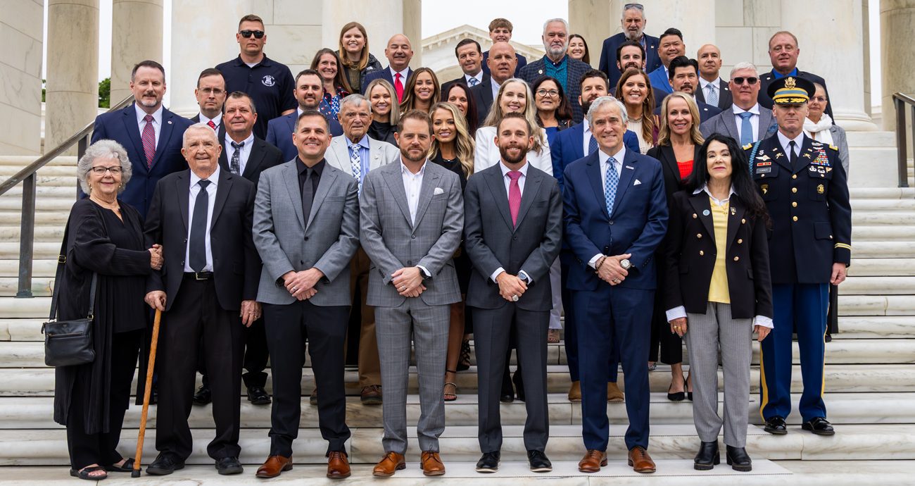 Ross Chastain, Justin Marks and their group pose for a picture at the Tomb of the Unknown Soldier wreath-laying ceremony on April 29, 2026 at Arlington National Cemetery in Arlington, Virginia.