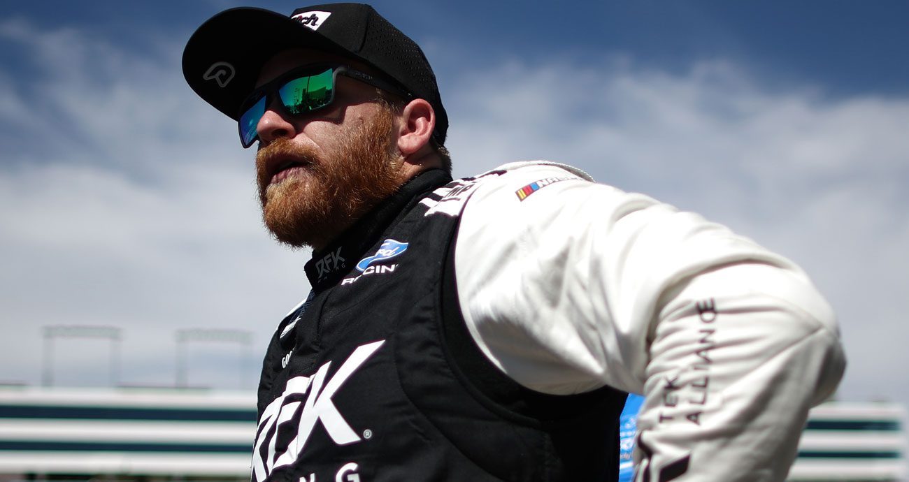 Chris Buescher looks on.
