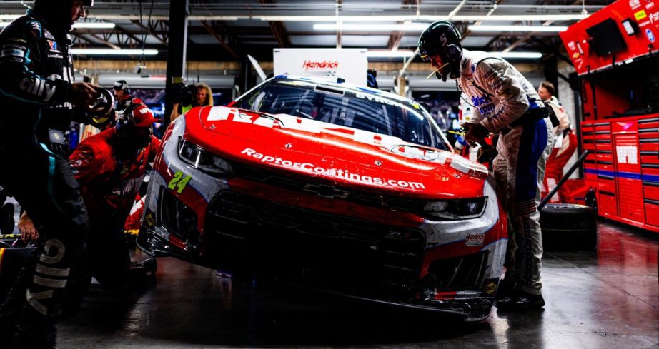 Race team works on damaged car.