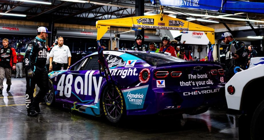 Race team tows in broken race car.