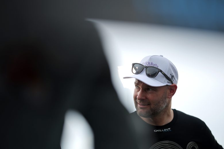Shane van Gisbergen looks on.