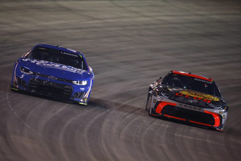Chase Briscoe races Kyle Larson.