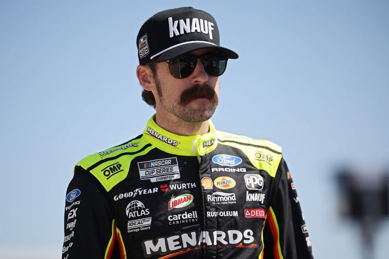 Ryan Blaney looks on.