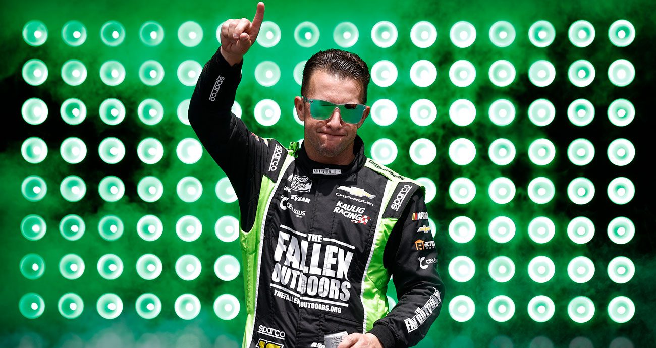 AJ Allmendinger points to the crowd before a NASCAR Cup Series race.