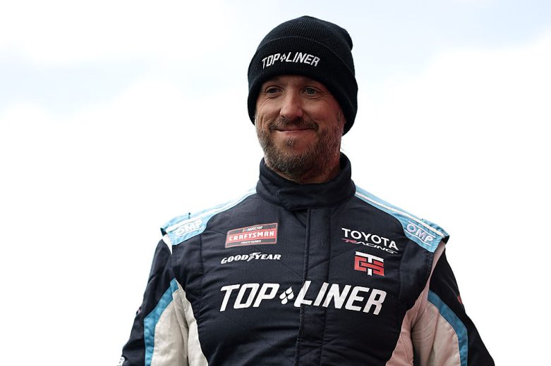 Adam Andretti looks on.