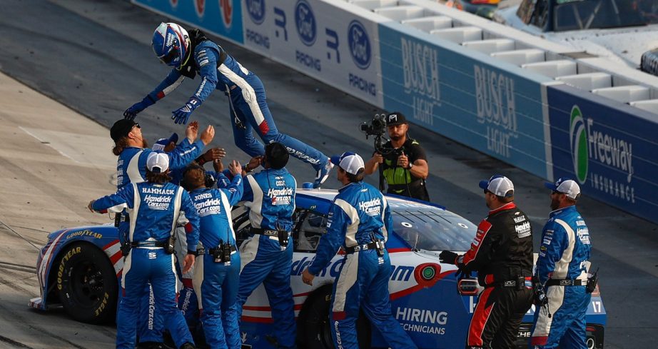 Corey Day leaps into the arms of his crew members after conquering Dover.