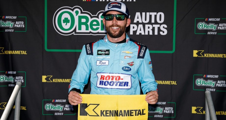 Ross Chastain hold pole flag.