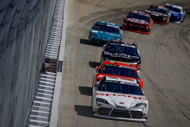 Harrison Burton leads a pack of cars