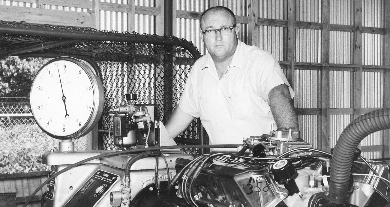 John Holman poses with a motor in 1950.
