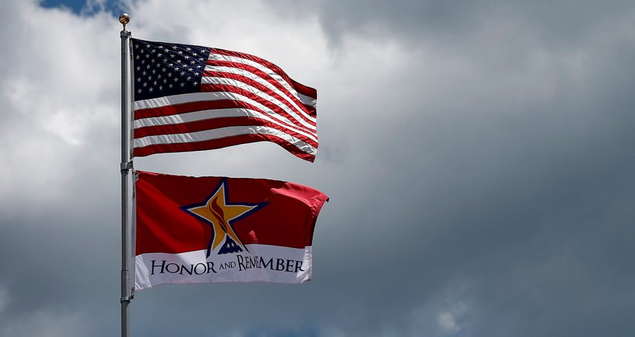 an american flag flies at Charlotte Motor Speedway