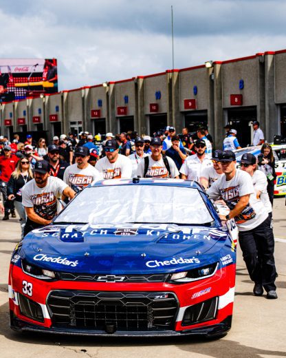 The No. 33 Richard Childress Racing Chevrolet gets pushed to the grid by members of the team wearing Kyle Busch shirts.