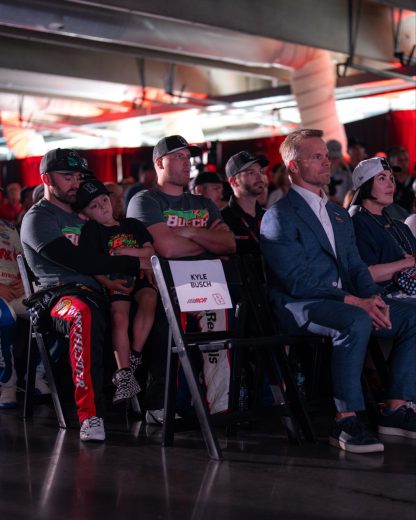 A view of the driver meeting with a seat designated for Kyle Busch.