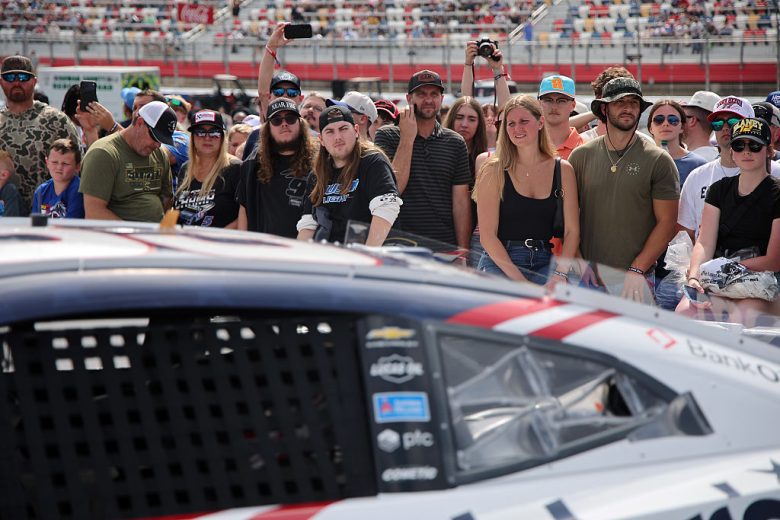 Fans watch as the No. 33 Richard Childress Racing Chevrolet gets pushed to the grid at Charlotte Motor Speedway.