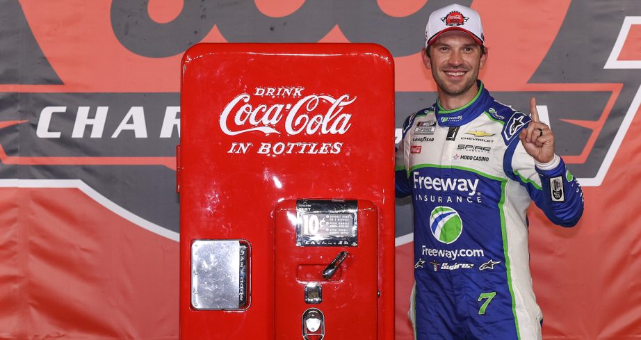 Daniel Suárez poses with an antique Coca-Cola machine in Victory Lane after winning the Coca-Cola 600 on May 24, 2026 at Charlotte Motor Speedway.