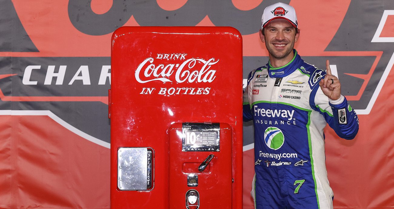 Daniel Suárez poses with an antique Coca-Cola machine in Victory Lane after winning the Coca-Cola 600 on May 24, 2026 at Charlotte Motor Speedway.