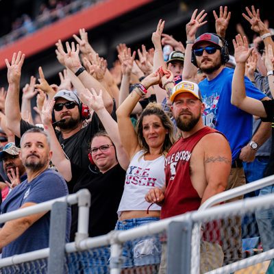 Fans hold up eight fingers to salute Kyle Busch on May 24, 2026 at Charlotte Motor Speedway
