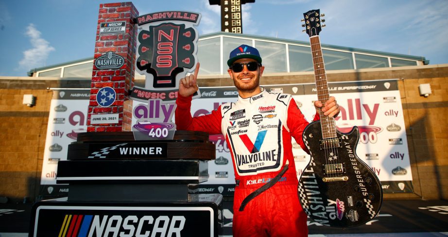 Kyle Larson poses for a photo in Victory Lane at Nashville Superspeedway.