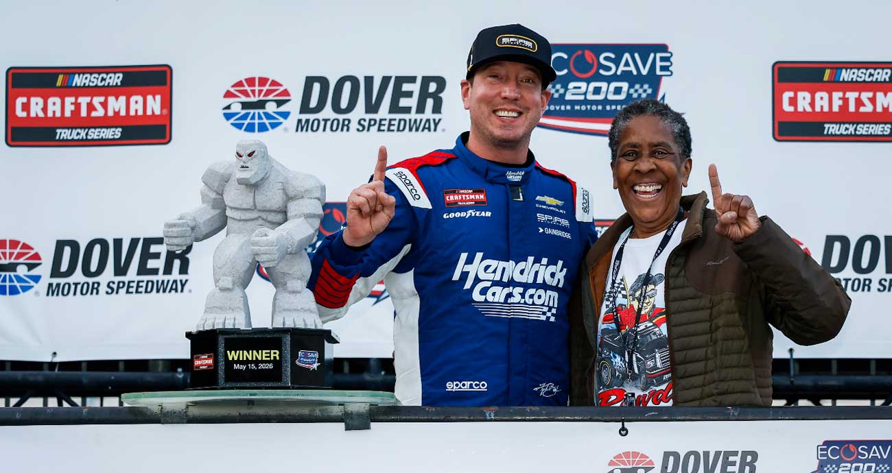 Darnette Vickers smiles and poses for a picture in Victory Lane with Kyle Busch