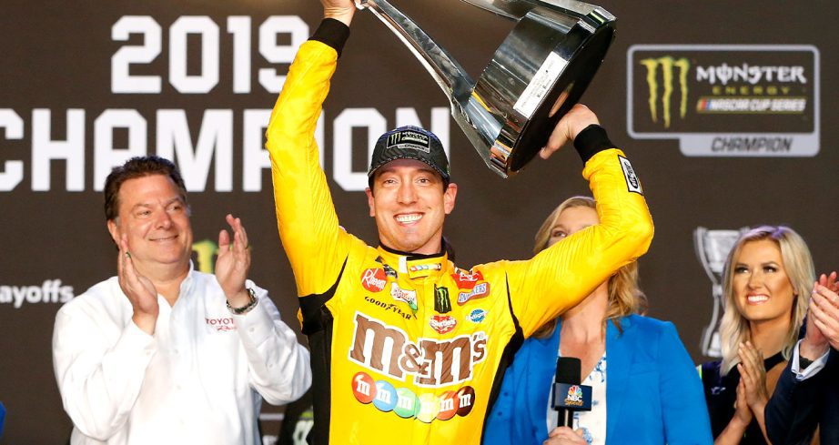 Kyle Busch hoists the trophy after winning the NASCAR Cup Series championship race at Homestead Speedway on November 17, 2019, in Homestead, Florida.