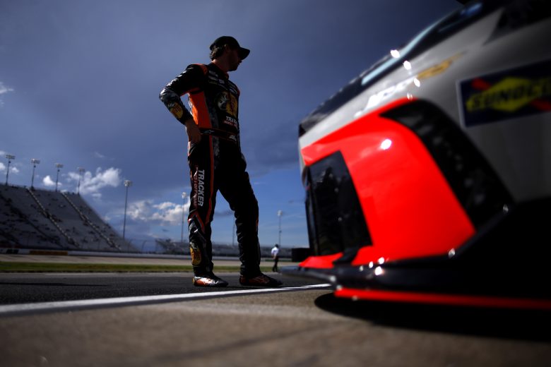 Chase Briscoe stands in front of his No. 19 Joe Gibbs Racing Toyota on pit road.
