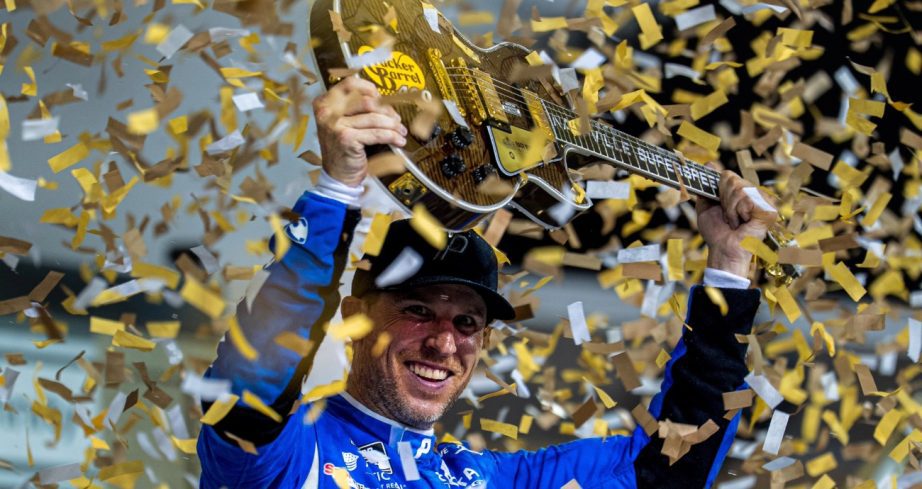 Denny Hamlin holds up guitar