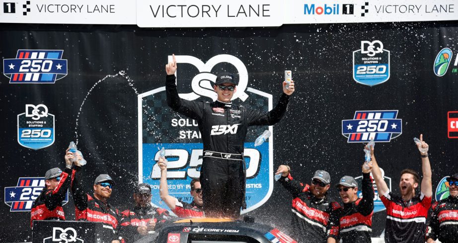 Corey Heim celebrates in Victory Lane following his NASCAR Craftsman Truck Series win at Michigan International Speedway.