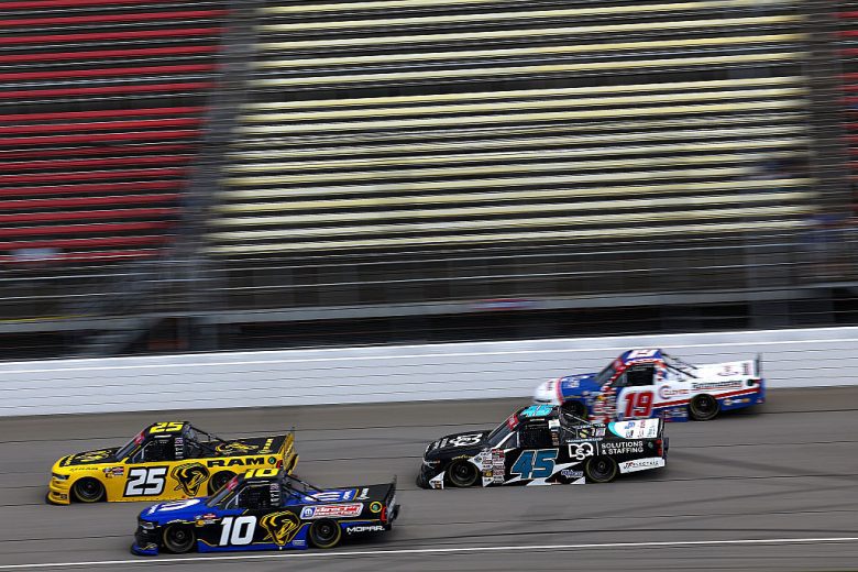NASCAR Craftsman Truck Series trucks race during practice at Michigan International Speedway.