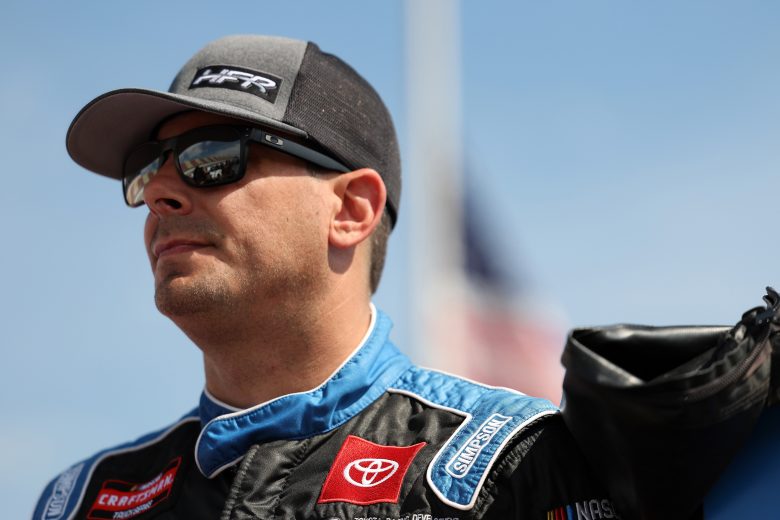 Stewart Friesen looks on.