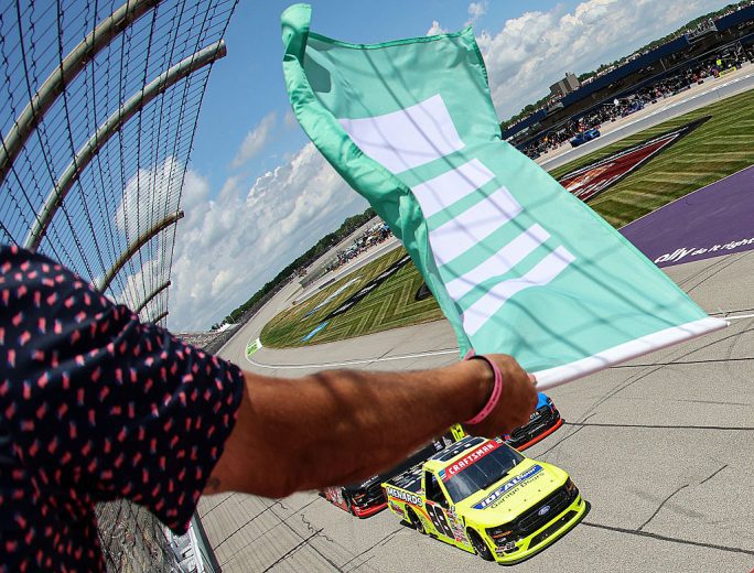 The green flag waves at Michigan International Speedway.