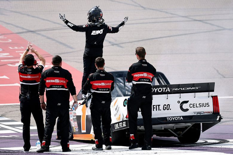 Corey Heim stands atop his No. 1 Truck and poses for the crowd at Michigan International Speedway.