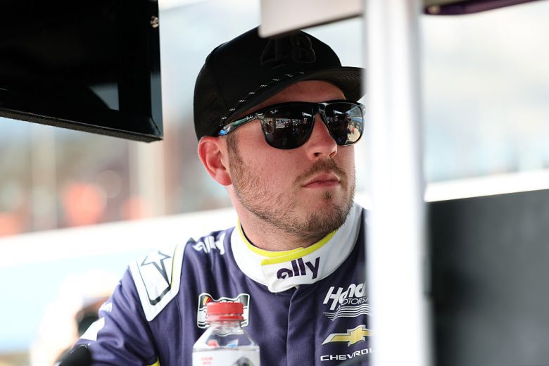 Alex Bowman looks on.