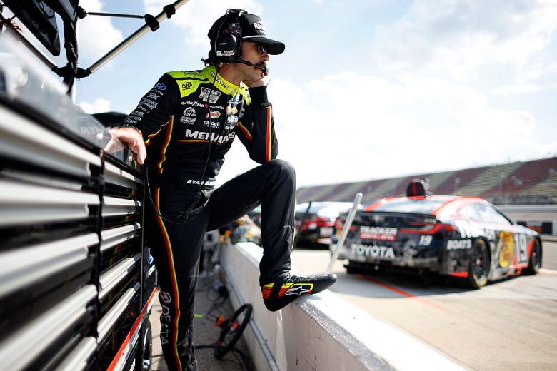 Ryan Blaney looks on.