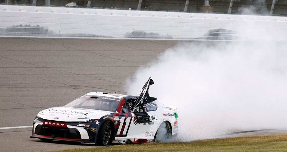 Denny Hamlin performs a burnout at Michigan.