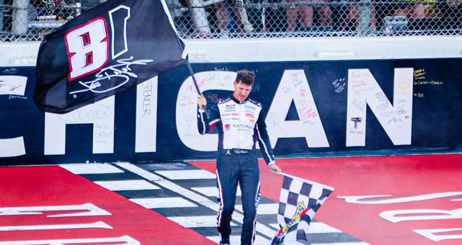 Denny Hamlin holds up Kyle Busch tribute flag.