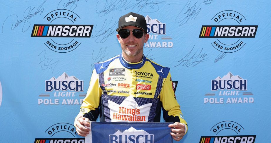 Denny Hamlin celebrates after winning the pole at Pocono.