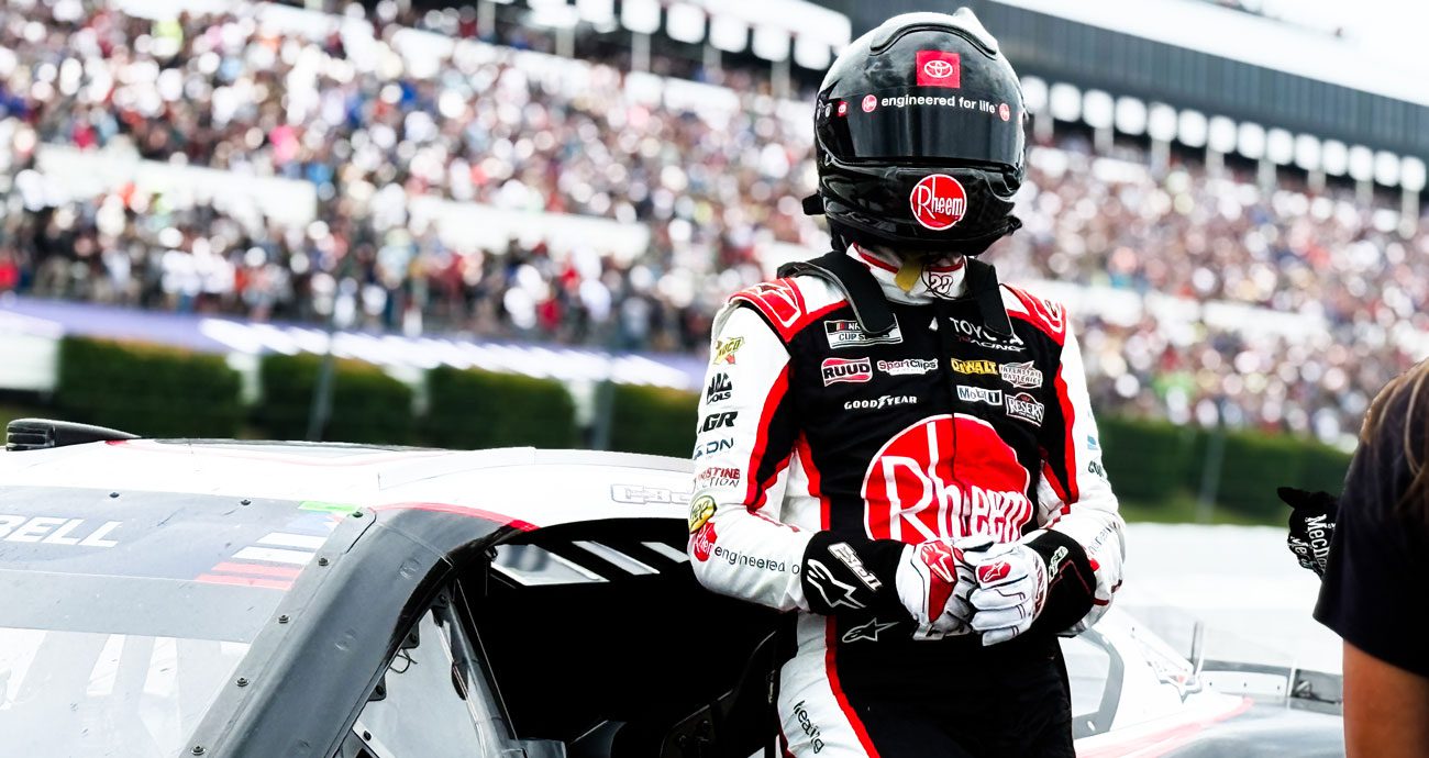 Christopher Bell stands next to his car after a NASCAR Cup Series race at Pocono.