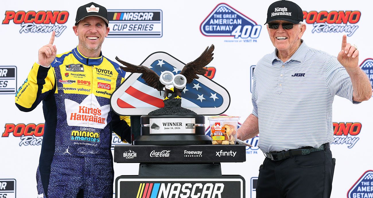 Denny Hamlin (L) poses with Joe Gibbs (R) in Victory Lane at Pocono Raceway.