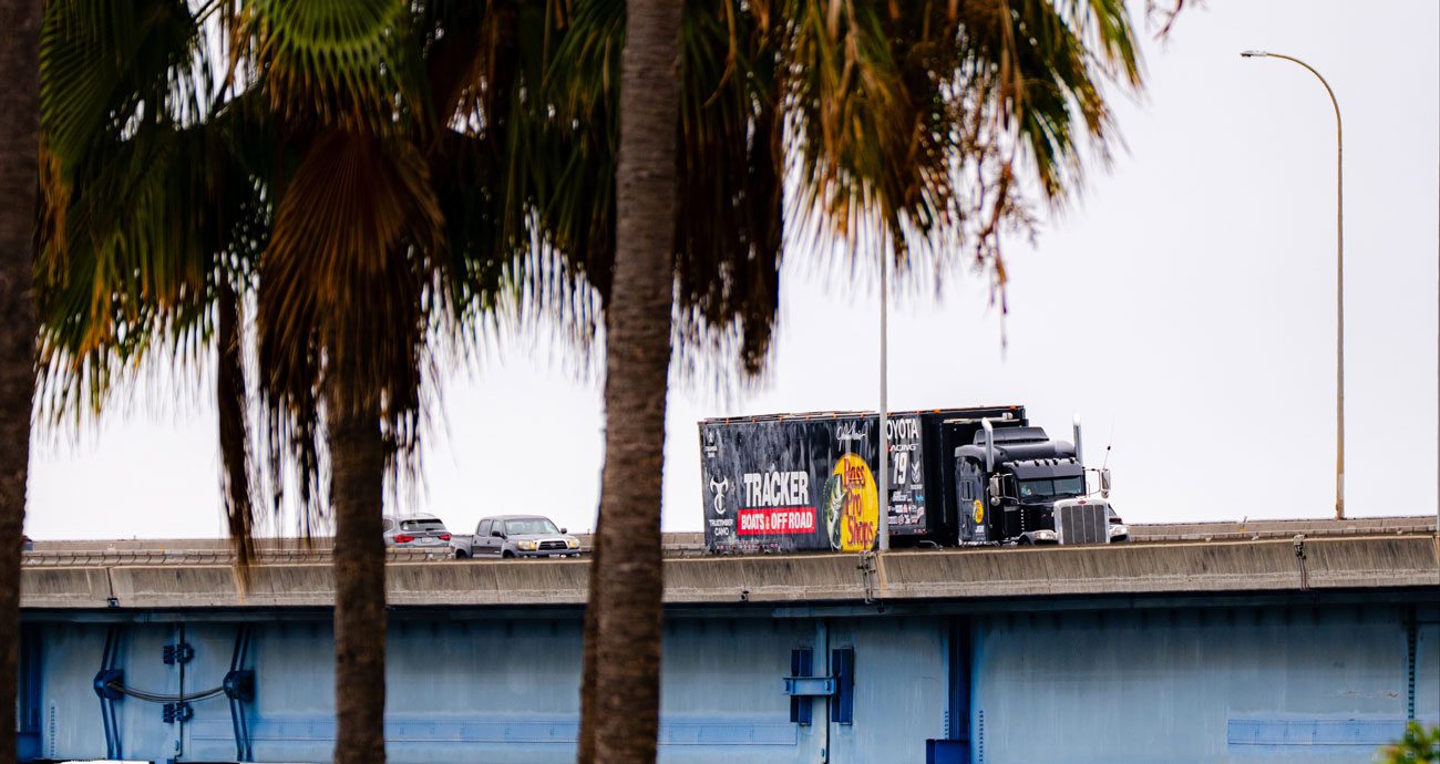 The No. 19 Joe Gibbs Racing hauler drives over the Coronado Bridge heading to Naval Base Coronado.