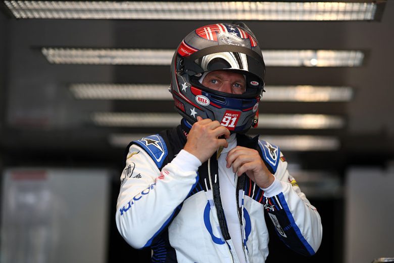 Kevin Magnussen looks on.