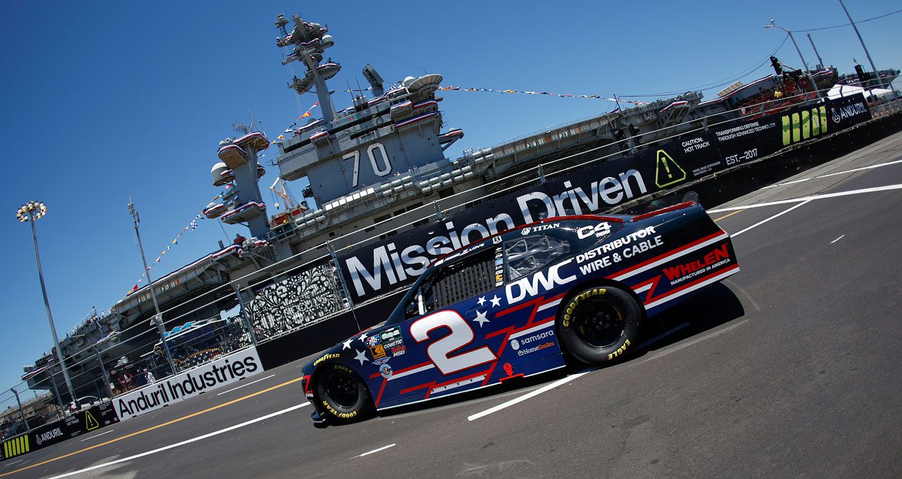 Jesse Love drives at Naval Base Coronado in San Diego next to the USS Carl Vinson.