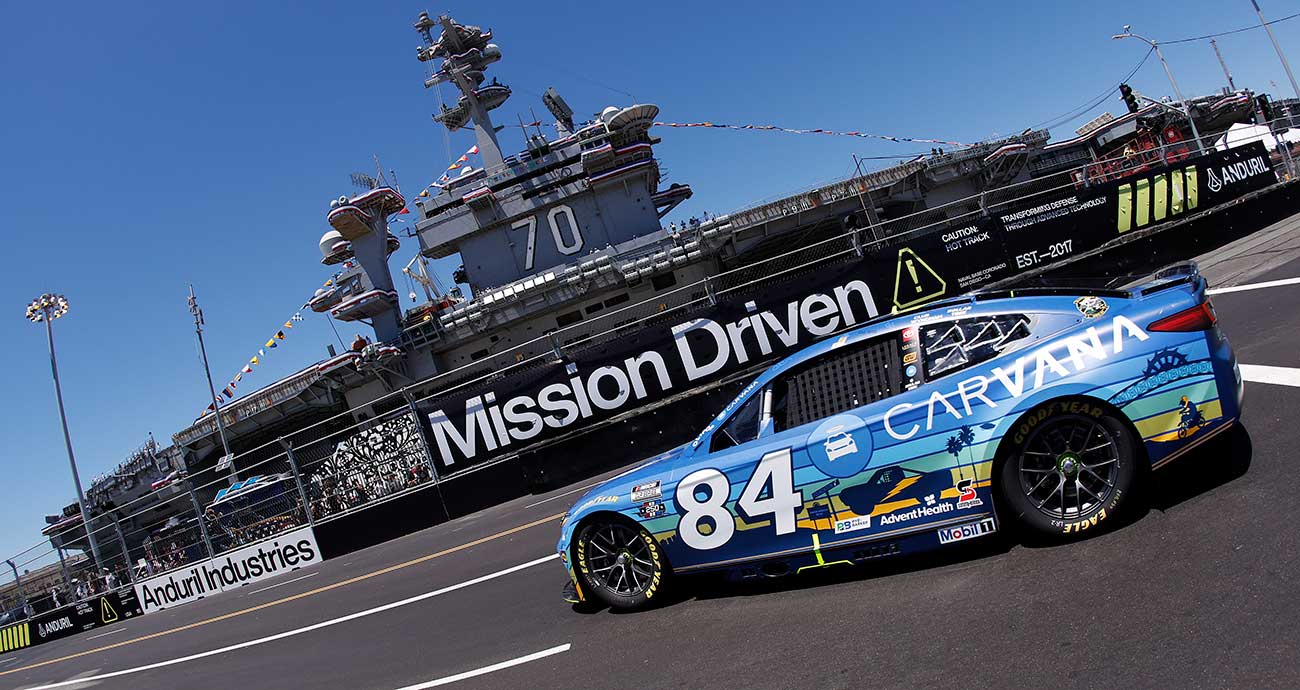 Jimmie Johnson's No. 84 Toyota rounds Turn 3 in front of the USS Carl Vinson at Naval Base Coronado