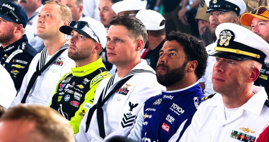 Drivers sit with members of the Navy during a meeting.