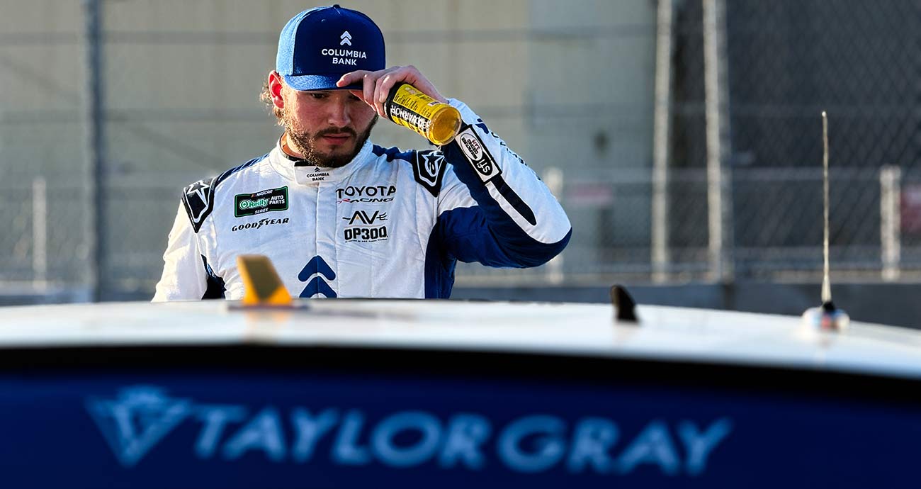 Taylor Gray tips his cap on pit road after the checkered flag in Saturday's O'Reilly Auto Parts Series race at Naval Base Coronado.
