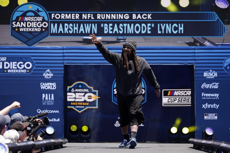 Marshawn Lynch walks onstage during pre-race ceremonies.