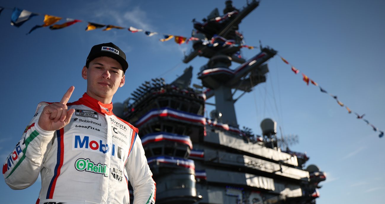 Corey Heim, driver of the No. 67 Mobil 1/O'Reilly Auto Parts Toyota, poses for a photo on the deck of the The USS Carl Vinson (CVN-70) after winning the NASCAR Cup Series Anduril 250 at Naval Base Coronado on June 21, 2026 in San Diego, California.