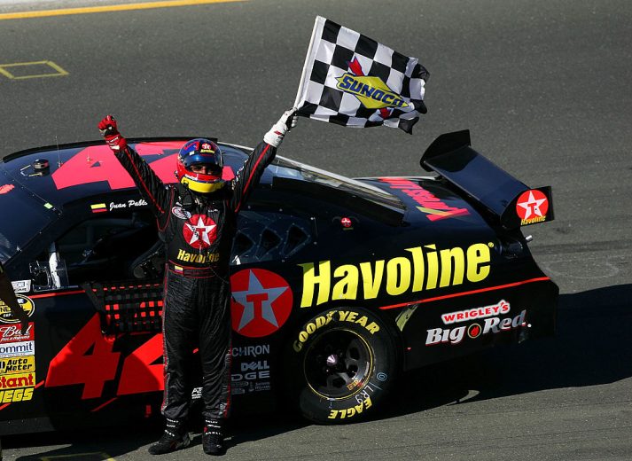 Juan Pablo Montoya raises the checkered flag.