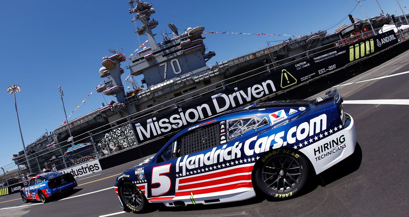 Kyle Larson drives past the USS Carl Vinson at Naval Base Coronado in a NASCAR Cup Series event.